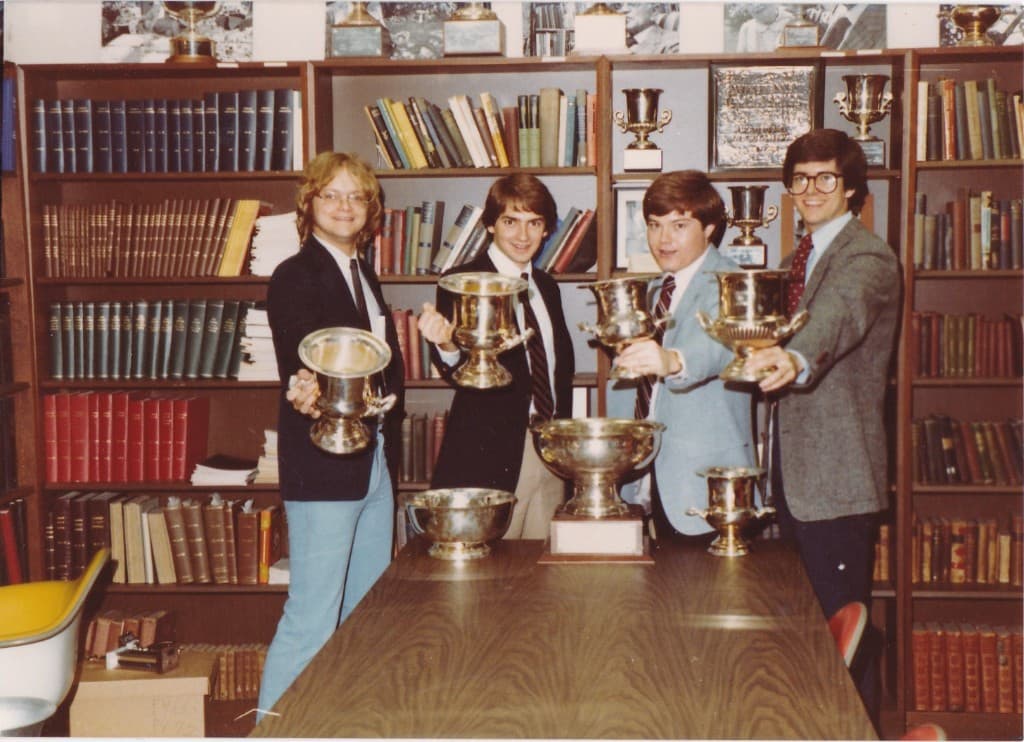 KU Debate team with trophies in the squad room, circa late 1970s